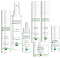 Seven NIKO skincare Organic Express bottles and a jar with white caps and white labels, arranged in a row against a plain white background.