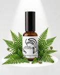 Bottle of Muskoka Wild Harvest product with green fern leaves on a white background